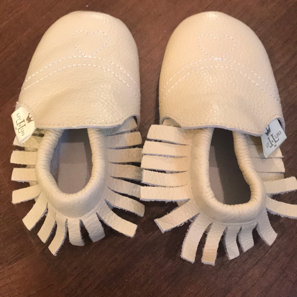 Cream colored infant shoes